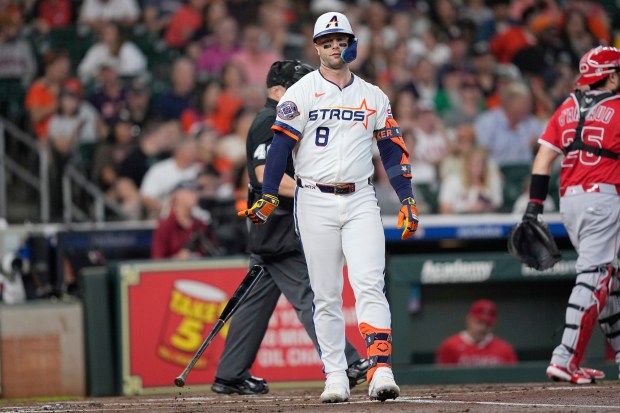 The Houston Astros’ Christian Walker throws his bat down after...