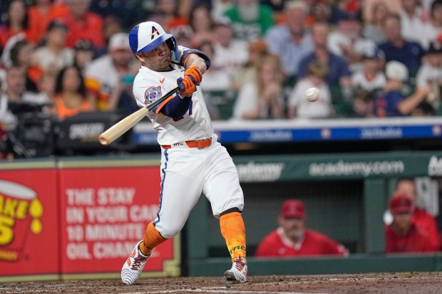 The Houston Astros’ Jose Altuve hits an RBI double during...