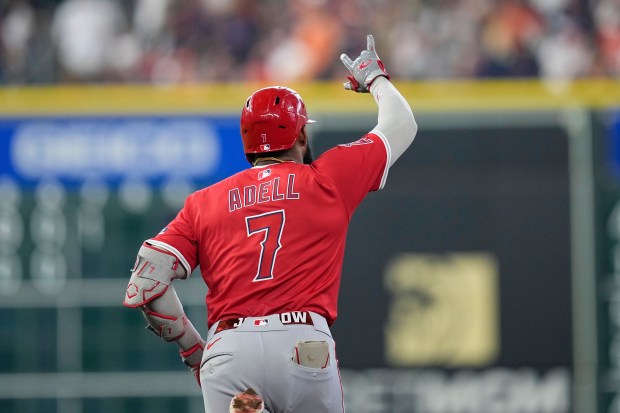 The Angels’ Jo Adell celebrates as he runs the bases...