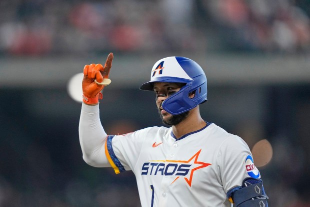 The Houston Astros’ Carlos Correa celebrates after hitting an RBI...