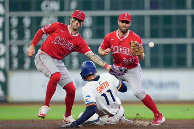 The Houston Astros’ Cam Smith (11) steals second base as...