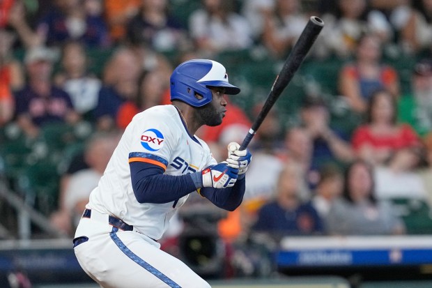 The Houston Astros’ Yordan Alvarez hits an RBI single during...