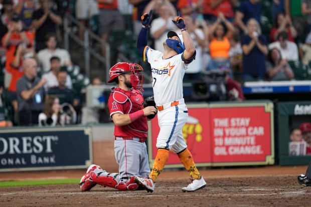 The Houston Astros’ Jose Altuve (27) celebrates after hitting a...