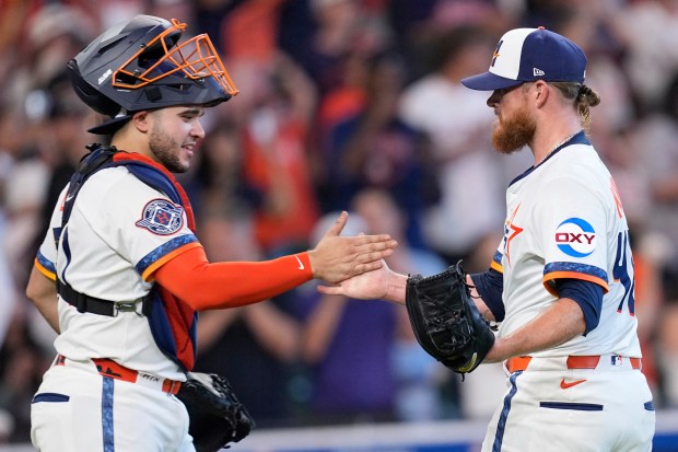 Houston Astros relief pitcher Craig Kimbrel, right, and Yainer Diaz...