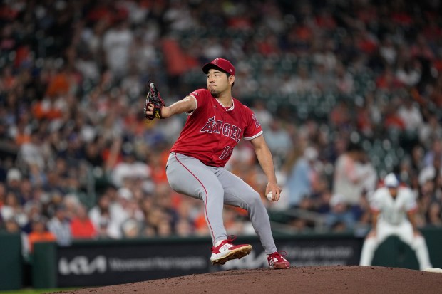 Angels starting pitcher Yusei Kikuchi throws to the plate during...