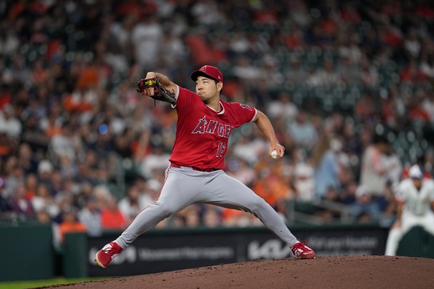 Angels starting pitcher Yusei Kikuchi throws to the plate during...