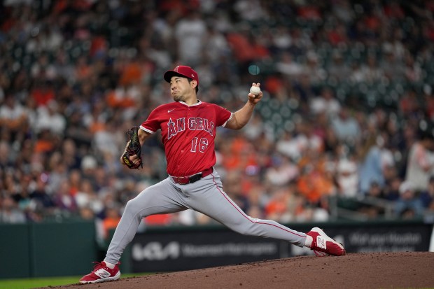 Angels starting pitcher Yusei Kikuchi throws to the plate during...