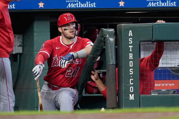 Angels star Mike Trout watches from the dugout during the...