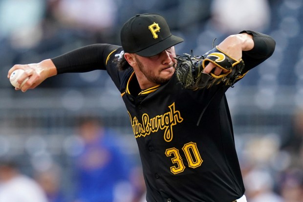 Pittsburgh Pirates starting pitcher Paul Skenes throws to the plate...