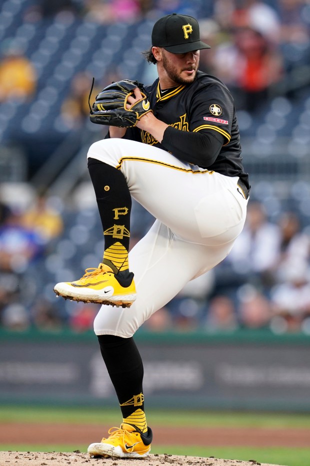 Pittsburgh Pirates pitcher Paul Skenes winds up to deliver during...