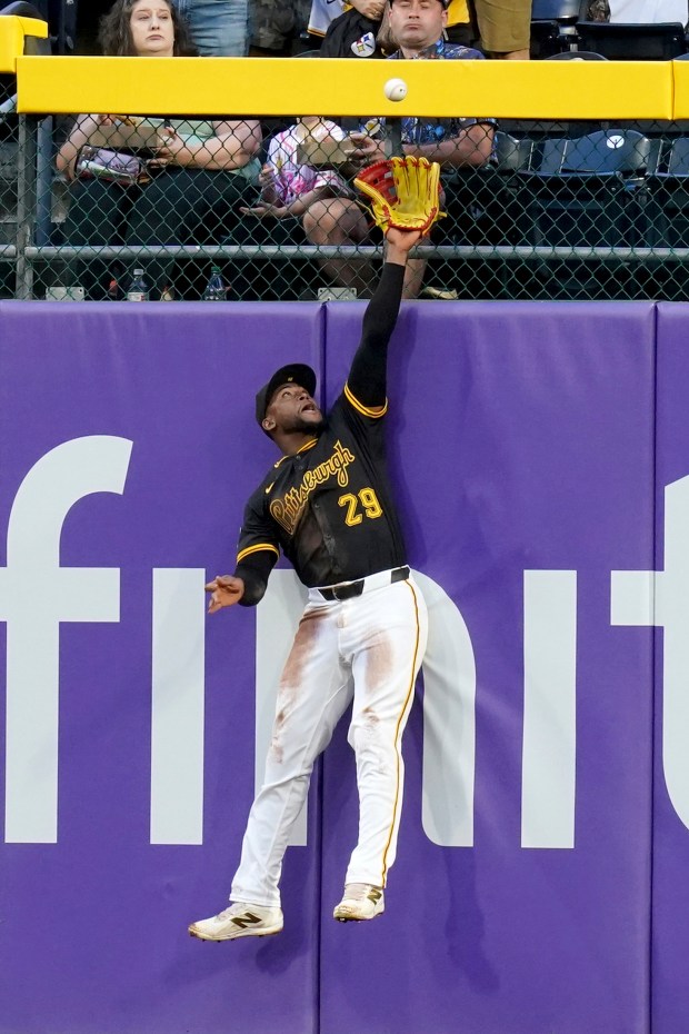 Pittsburgh Pirates center fielder Alexander Canario reaches but cannot catch...