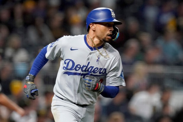 The Dodgers’ Mookie Betts rounds the bases after hitting a...