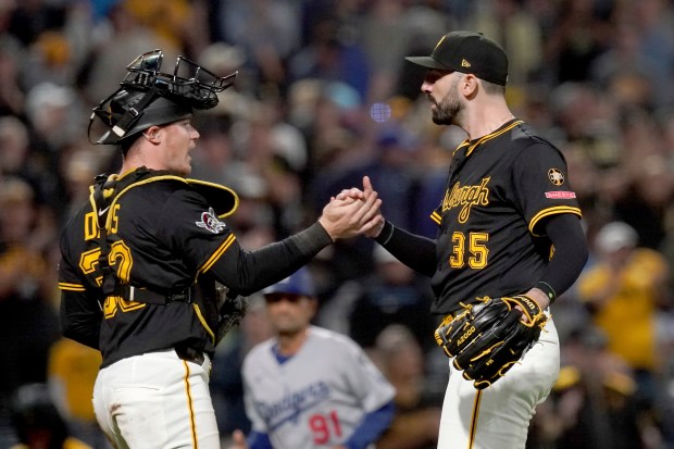 Pittsburgh Pirates relief pitcher Colin Holderman, right, celebrates with catcher...