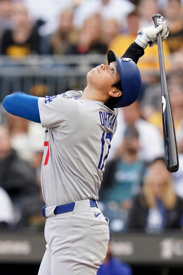 Dodgers star Shohei Ohtani watches his foul ball during the...