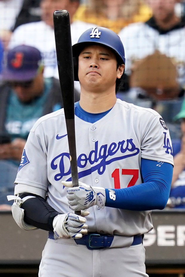 Dodgers star Shohei Ohtani warms up before a baseball game...