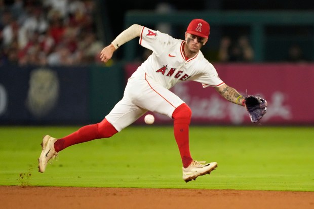 Angels shortstop Zach Neto fields a ball his for a...
