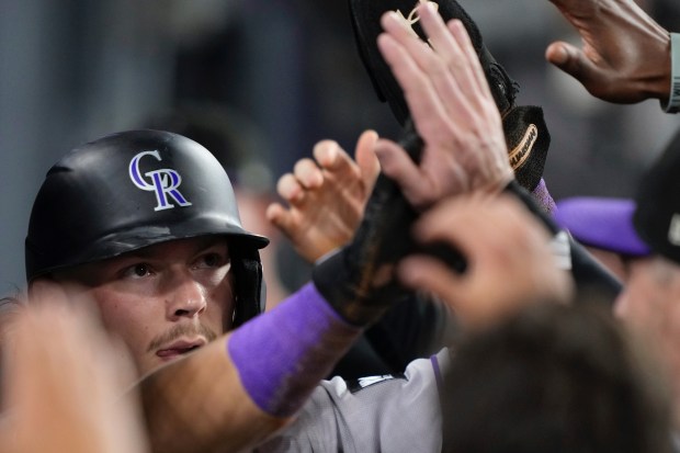 Colorado Rockies’ Jordan Beck is congratulated by teammates in the...