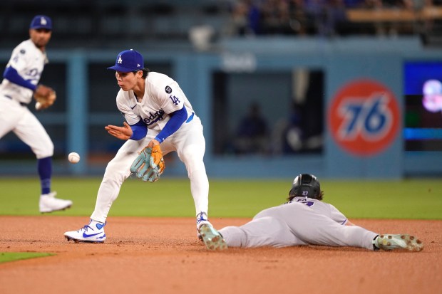 The Colorado Rockies’ Jordan Beck steals second base as Dodgers...