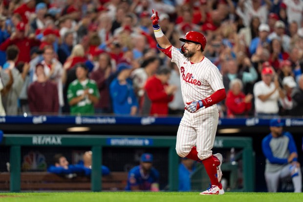 The Phillies' Kyle Schwarber celebrates his three-run home run during the seventh inning against the Mets Tuesday. With it, Schwarber became just the second Phillie to hit 50 homers in a season. (AP Photo/Chris Szagola)