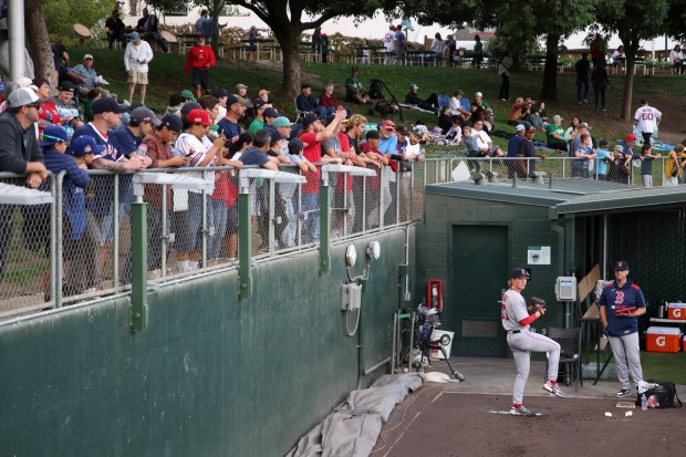 Fans watch as Boston Red Sox starting pitcher Connelly Early warms up before a baseball game against the Athletics as he makes his MLB Debut, Tuesday, Sept. 9, 2025, in West Sacramento, Calif. (AP Photo/Scott Marshall)
