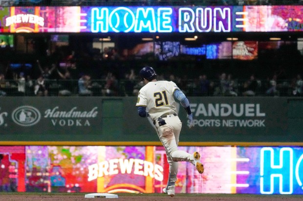 The Milwaukee Brewers’ Christian Yelich runs the bases after hitting...