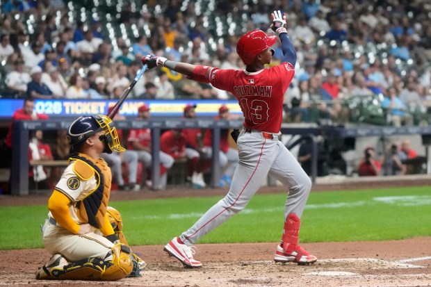The Angels’ Denzer Guzman hits a solo home run during...