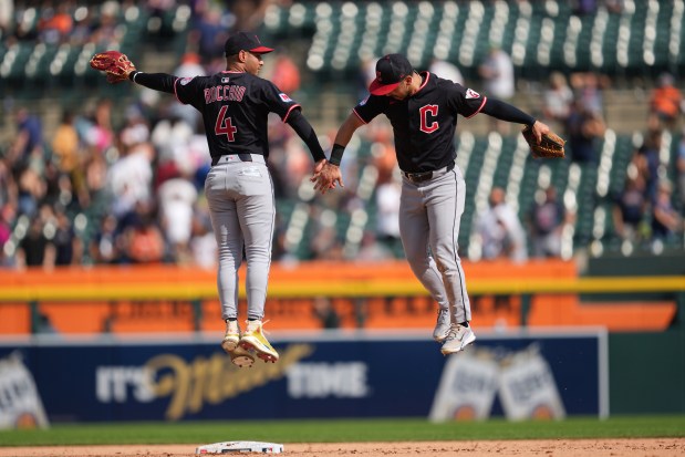 Cleveland Guardians' Brayan Rocchio (4) and Steven Kwan (38) celebrate after the final out against the Detroit Tigers during the ninth inning of a baseball game Thursday, Sept. 18, 2025, in Detroit. (AP Photo/Paul Sancya)