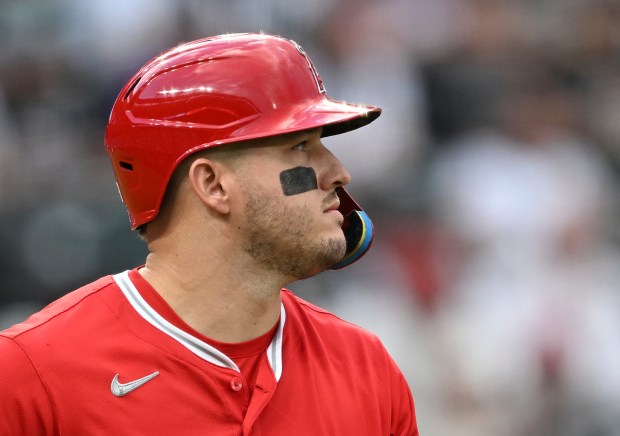 Angels designated hitter Mike Trout walks to first bases after...