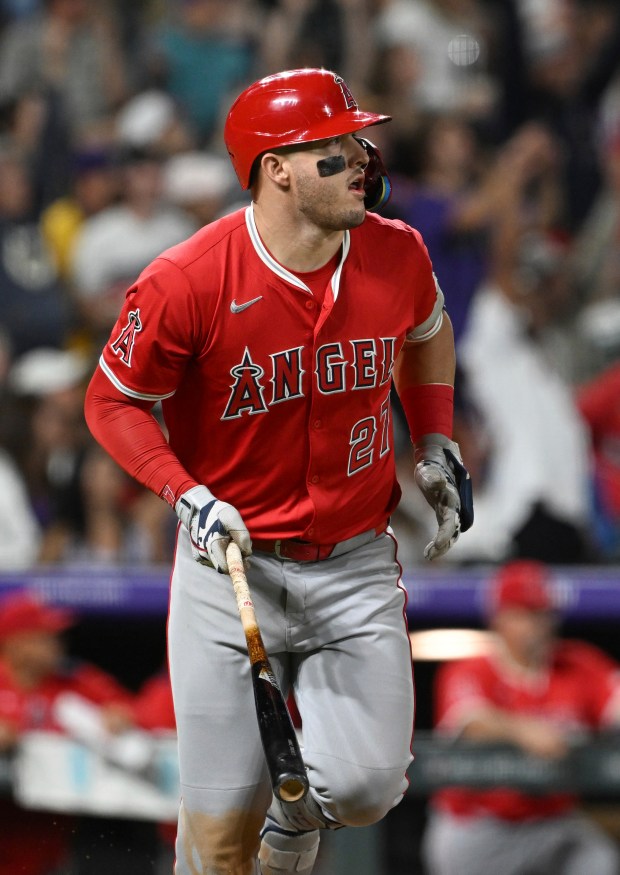 Angels designated hitter Mike Trout watches his hit clear the...