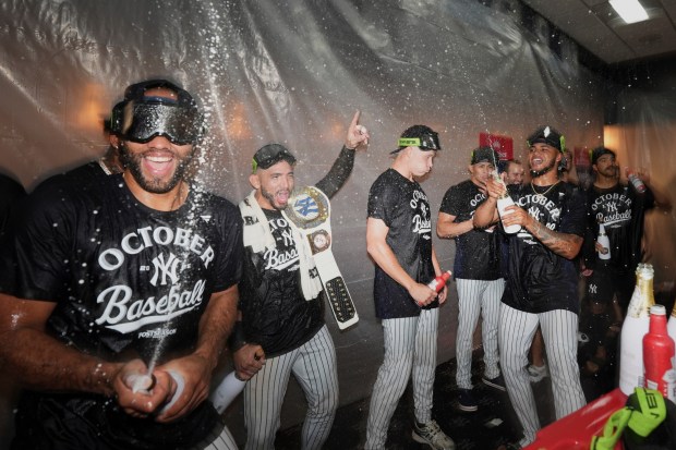 The New York Yankees celebrate after they clinched playoff berth a baseball game against the Chicago White Sox Tuesday, Sept. 23, 2025, in New York. (AP Photo/Frank Franklin II)