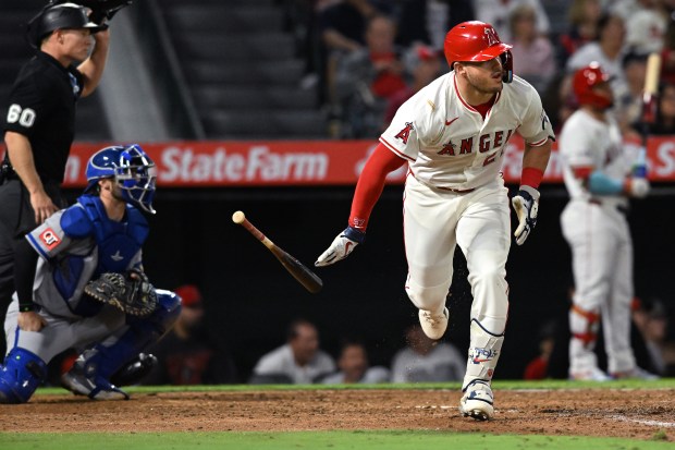 Angels star Mike Trout drops his bat as he watches...