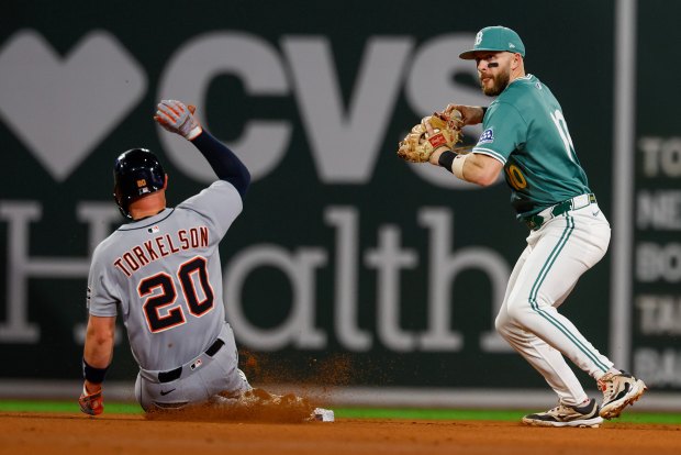 Detroit Tigers first base Spencer Torkelson (20) slides into second base as Boston Red Sox shortstop Trevor Story (10) turns the a double play in the seventh inning of a baseball game, Friday, Sept. 26, 2025, in Boston. (AP Photo/Greg M. Cooper)