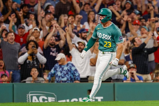 Boston Red Sox's Romy Gonzalez (23) screams as he rounds third base on the way to score the winning run on a triple hit by Ceddanne Rafaela (3) in the ninth inning of a baseball game against the Detroit Tigers, Friday, Sept. 26, 2025, in Boston. (AP Photo/Greg M. Cooper)