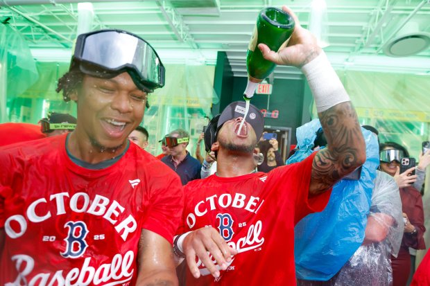 Boston Red Sox pitcher Brayan Bello (left) and outfielder Ceddanne Rafaela celebrate after defeating the Detroit Tigers in a baseball game to advance to eh postseason, Friday, Sept. 26, 2025, in Boston. (AP Photo/Greg M. Cooper)
