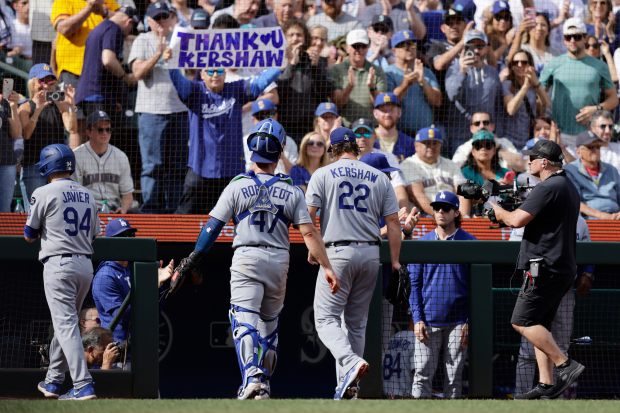 Dodgers pitcher Clayton Kershaw (22) and catcher Ben Rortvedt, center...