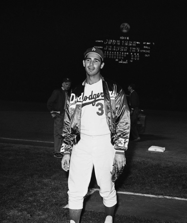 Dodgers pitcher Sandy Koufax walks off the mound after posing...