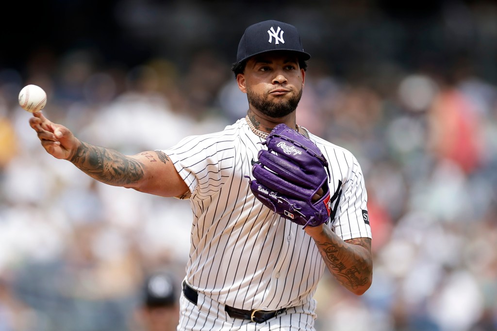 Luis Gil pitching a baseball.