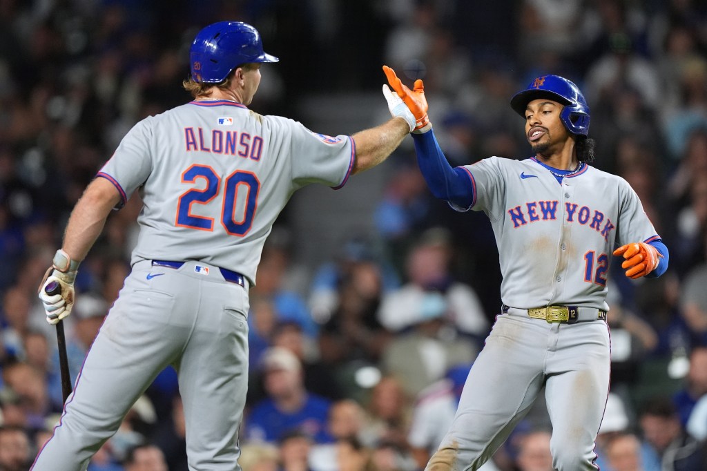 New York Mets' Francisco Lindor (12) celebrates with Pete Alonso (20) after hitting a solo home run during the third inning of a baseball game against the Chicago Cubs in Chicago, Thursday, Sept. 25, 2025. 