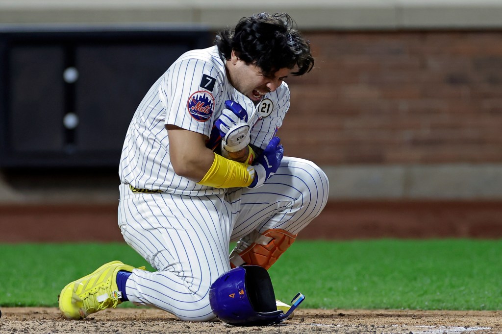 New York Mets' Francisco Alvarez reacts after being hit by a pitch during the eighth inning of a baseball game against the San Diego Padres, Tuesday, Sept. 16, 2025, in New York. 