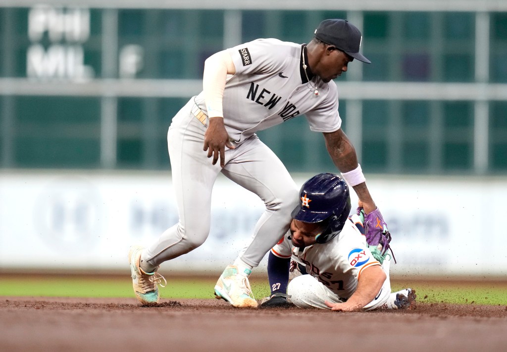 New York Yankees second baseman Jazz Chisholm Jr., left, catches Houston Astros' Jose Altuve stealing second base during the third inning.