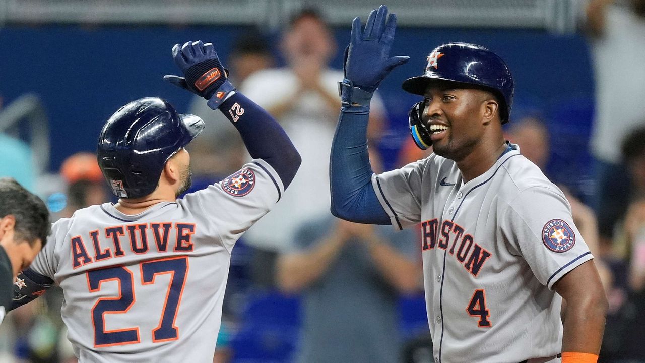 Houston Astros' Jose Altuve celebrates after hitting a two-run homer that brought home Jesus Sanchez (4), in the first inning of a baseball game against the Miami Marlins, Tuesday, Aug. 5, 2025, in Miami. (AP Photo/Rebecca Blackwell)