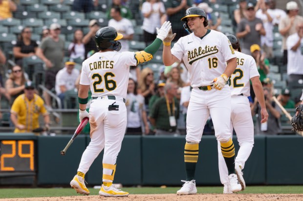 Athletics' Nick Kurtz, right, celebrates with Carlos Cortes, left, after hitting a two-run home run during the eighth inning of a baseball game against the Kansas City Royals, Sunday, Sept. 28, 2025, in West Sacramento, Calif. (AP Photo/Sara Nevis)