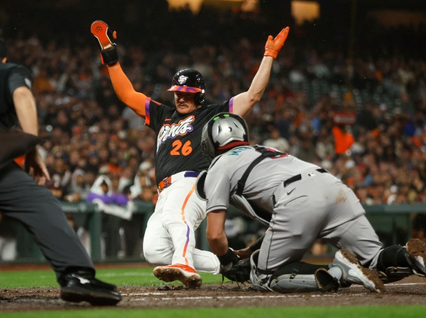 San Francisco Giants' Matt Chapman (26) scores a run off...