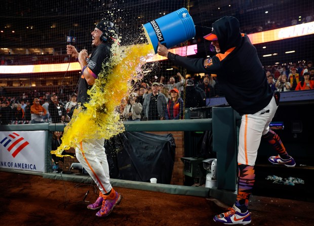 San Francisco Giants' Willy Adames (2) has Gatorade dunked on...