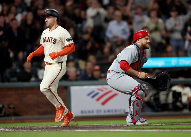 San Francisco Giants’ Patrick Bailey #14 scores past St. Louis...