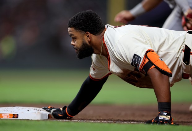 San Francisco Giants’ Heliot Ramos #17 scrambles back to first...