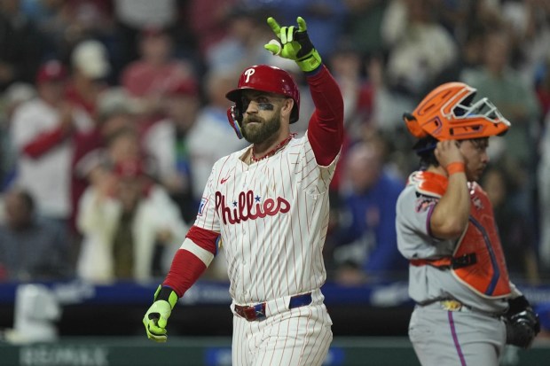 Philadelphia Phillies' Bryce Harper celebrates hitting a home run off New York Mets pitcher Ryne Stanek of during the seventh inning of a baseball game, Wednesday, Sept. 10, 2025, in Philadelphia. (AP Photo/Matt Rourke)