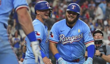Texas Rangers' Jake Burger, front right, and Josh Jung celebrate after scoring on a Burger home run during the sixth inning of a baseball game against the Houston Astros, Sunday, Sept. 7, 2025, in Arlington, Texas. (AP Photo/LM Otero)