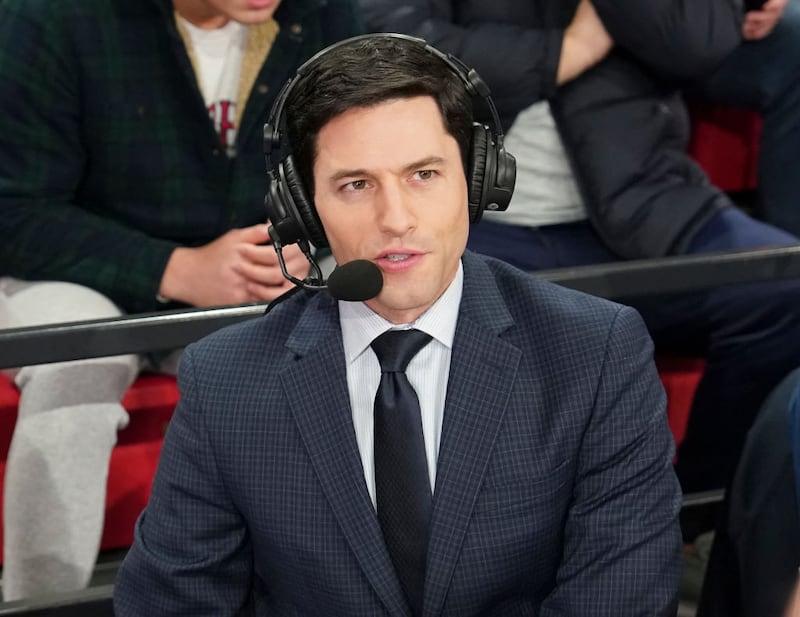 Alex Faust sits in the booth with headphones and microphone.