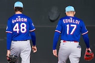 Texas Rangers pitchers Jacob deGrom and Nathan Eovaldi head for a practice field before a...